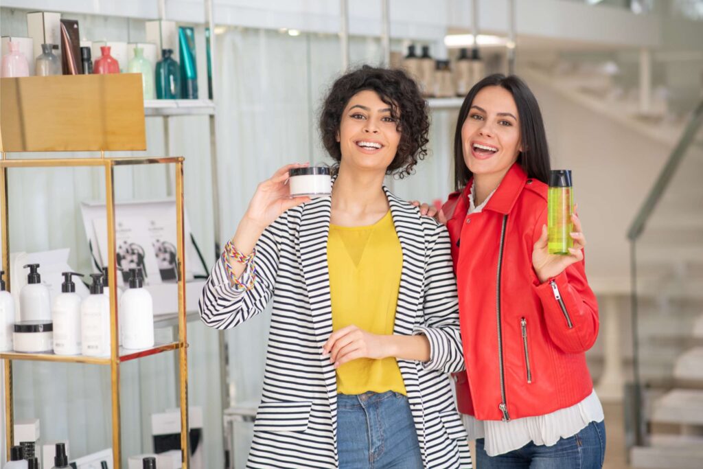 2 girls showing their best selling products